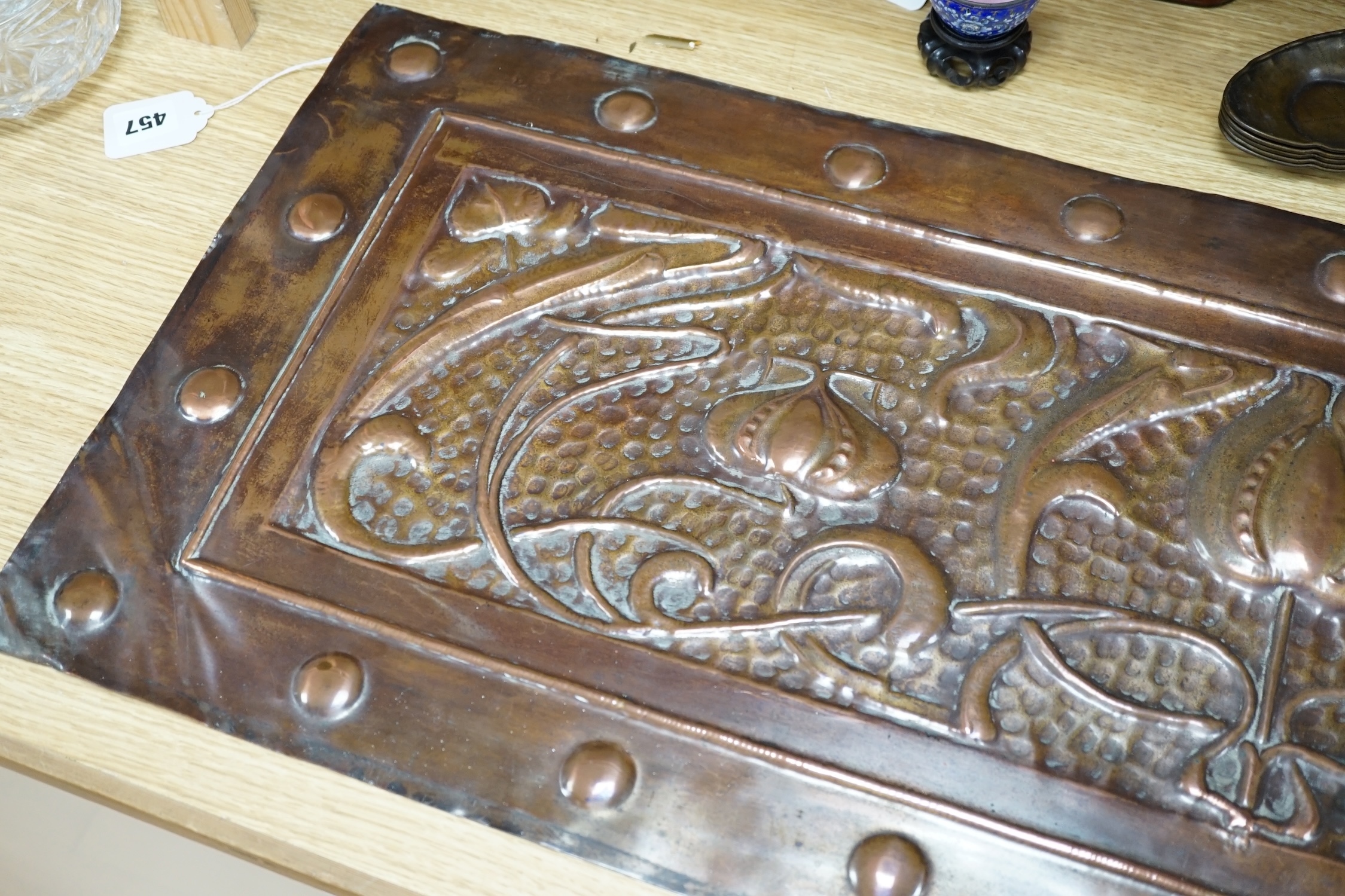 An Art Nouveau copper panel, embossed with stylised flowers and roundels, 39 x 99cm. Condition - fair